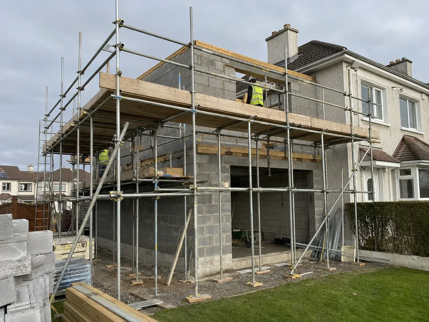 Safe tube-and-fitting scaffolding erected by Ainscaff for a two-storey house extension and blockwork project in a Dublin residential estate.