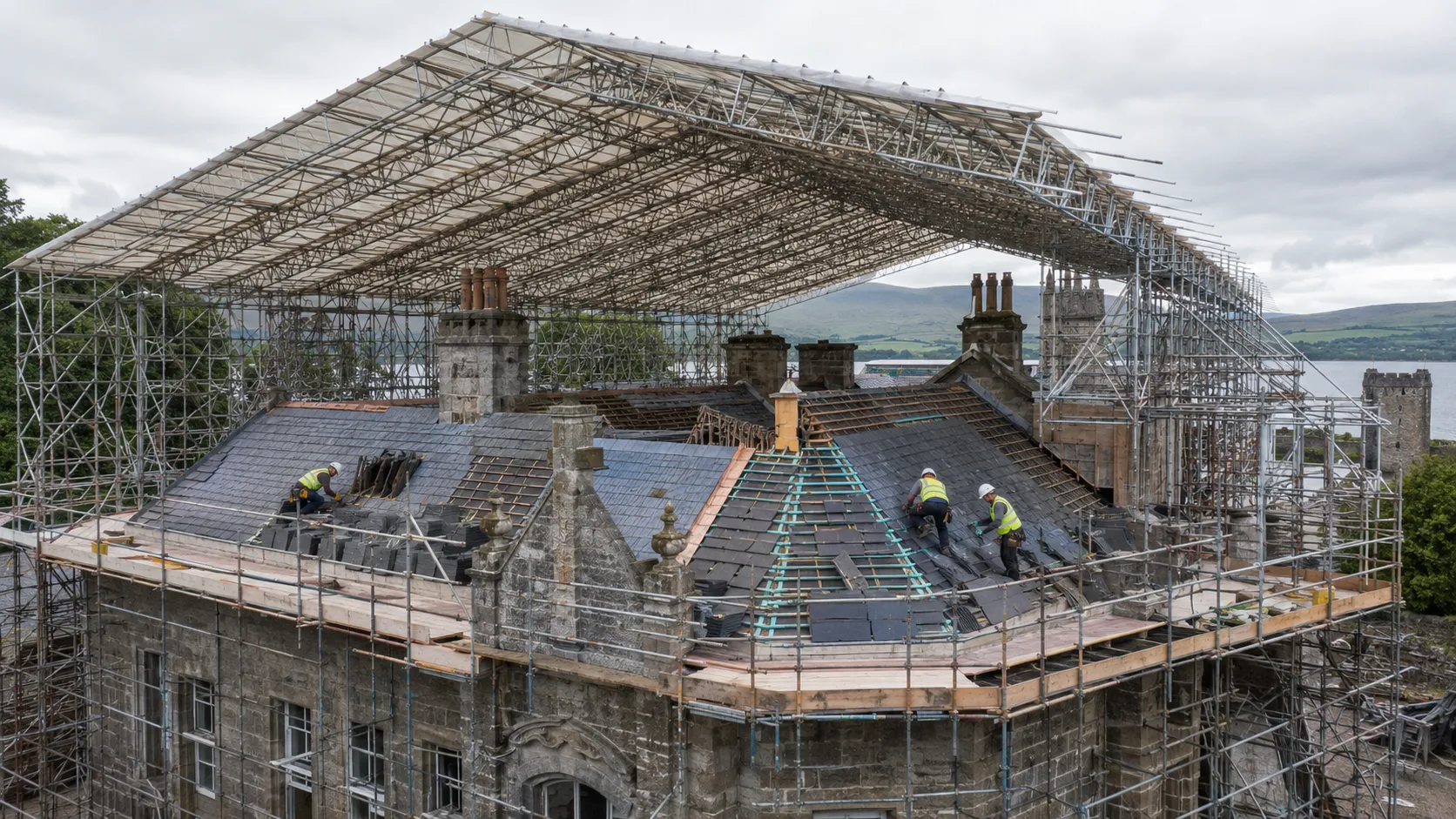 A bespoke temporary roof structure protecting a listed heritage property while traditional slate, clay tiles, or lead are carefully sorted and relaid.