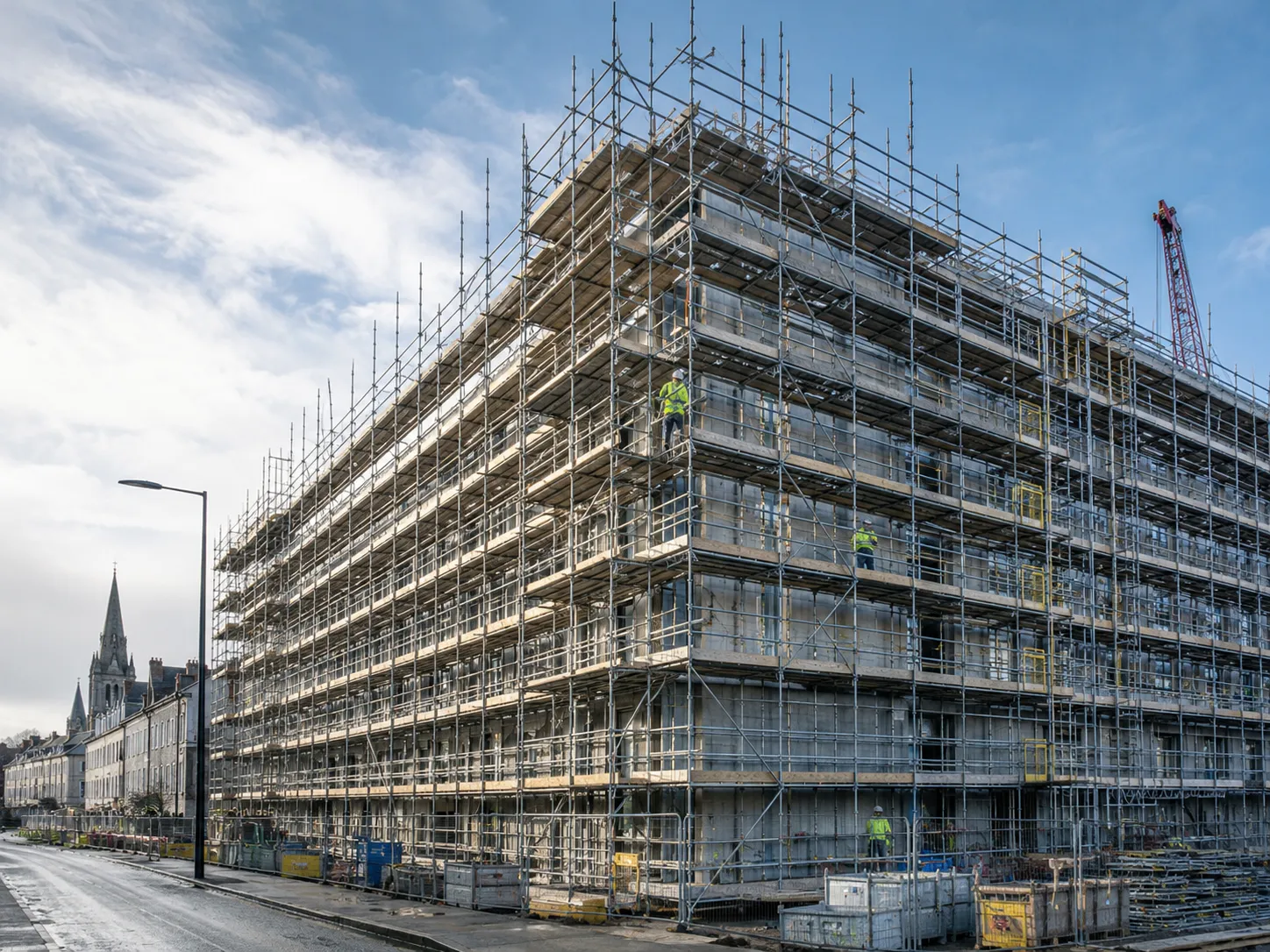 Scaffolding hire Dublin on semi-detached houses showing multiple lifts.