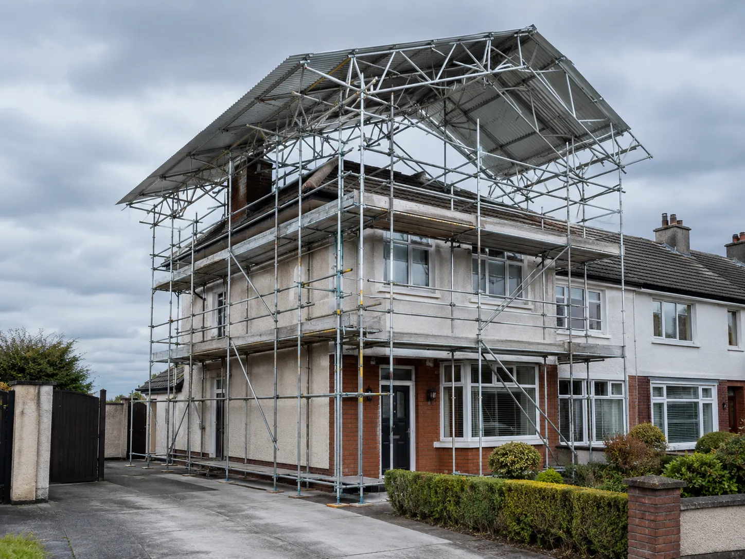 A temporary roof scaffold system including a base access scaffold and roof frame installed on a standard domestic semi-detached house in Ireland.
